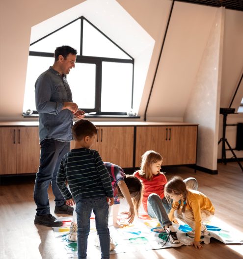 kids with father playing twister game at home. Family activity
